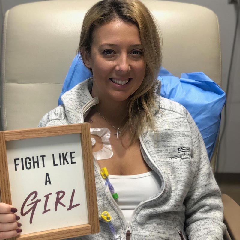 Morgan Gaynor holding framed picture that reads, Fight like a girl