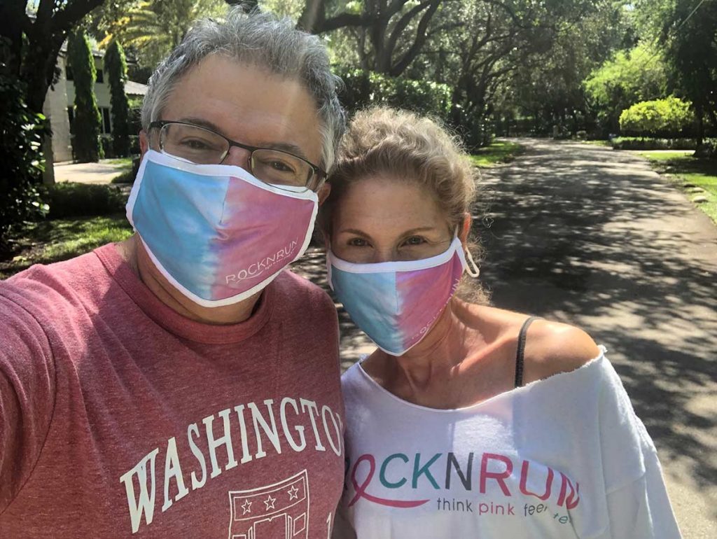 Amy Hollub, wearingRocknRun t-shirt, and her husband, both wearing cloth masks, posing for photo