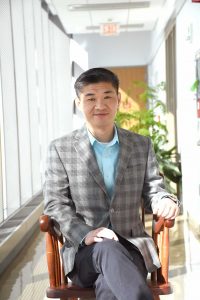 Rugang Zhang sitting in chair