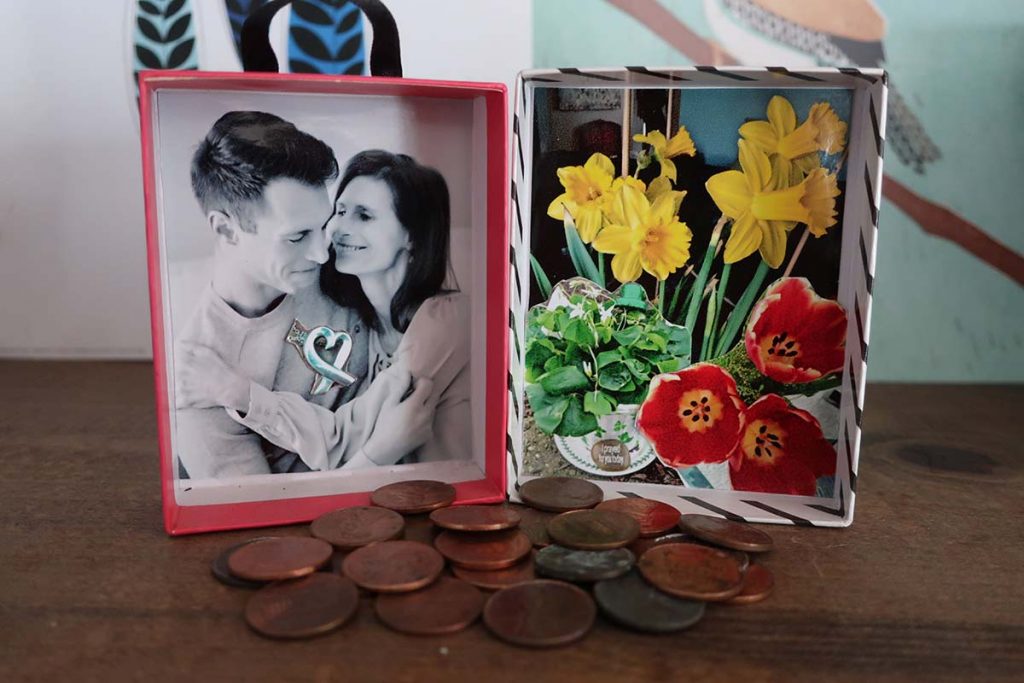 A table with a framed photo of Jonathan and his mother embracing, next to framed flowers 