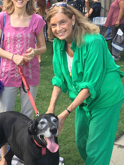 Gael Ross wearing green outfit, petting dog