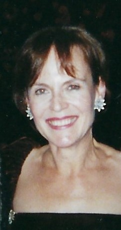 Edmée Firth wearing earrings and smiling
