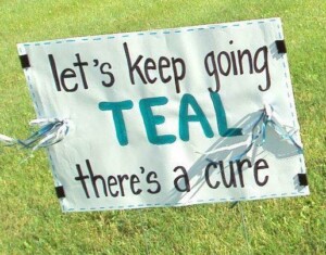 Sign on grass reads "let's keep going TEAL there's a cure"