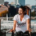 ovarian cycle instructor on bike in front of skyline