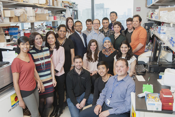 Large group of researchers posing in lab