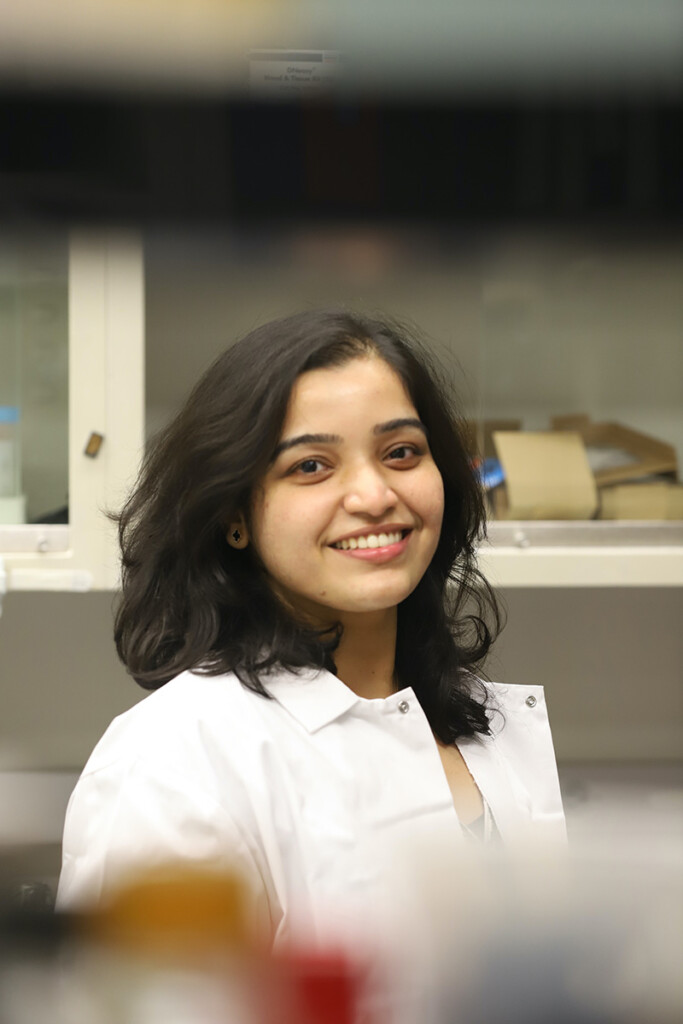Dr. Amrita Salvi in research lab wearing lab coat