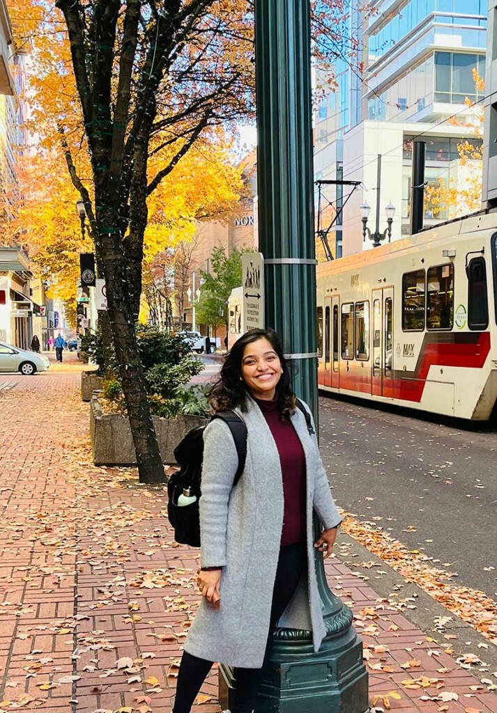Dr. Amrita Salvi walking outdoors in the fall