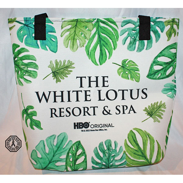 White canvas tote with palm leaves background and black lettering reading The White Lotus Resort & Spa HBO Original