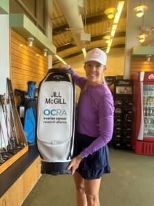 Jill McGill poses with Ovarian Cancer Research Alliance golf bag