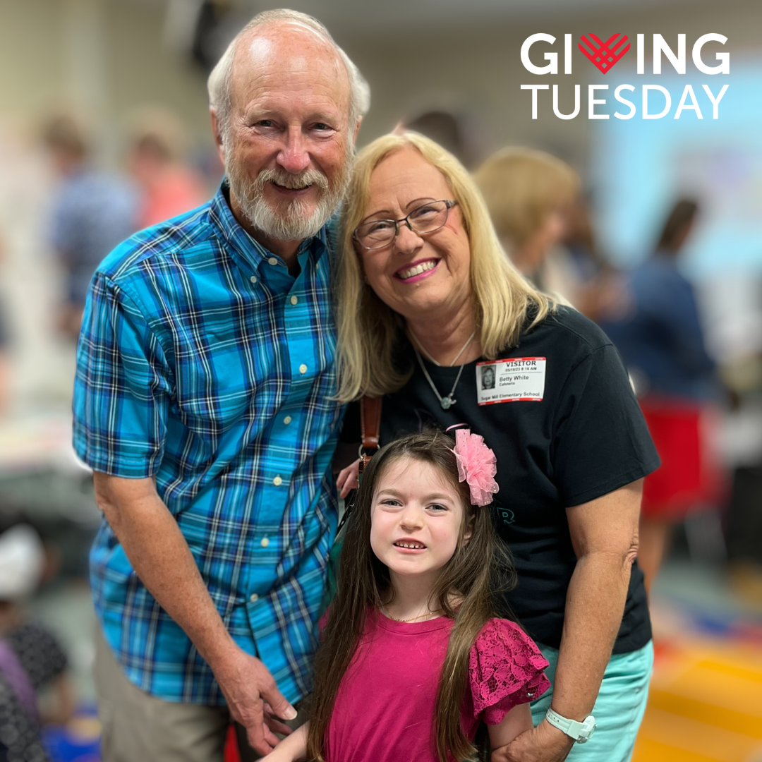 Family of three, with an older man and woman, and a young girl, posing together and smiling brightly. Giving Tuesday logo appears in upper right corner.