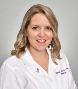 Photo: Dr. Bethany Hannafon smiling in professional headshot, wearing white lab coat