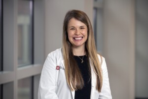 Photo: headshot of Dr. Laura Chambers wearing white lab coat