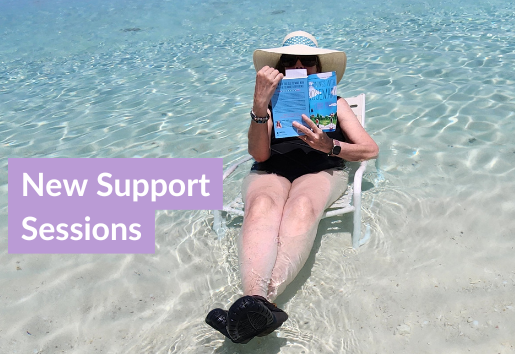 Woman sitting on beach char in clear water