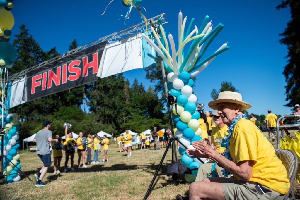 Dr. Saul Rivkin, founder of the OCRA Rivkin Family SummeRun, cheers on participants at the finish line
