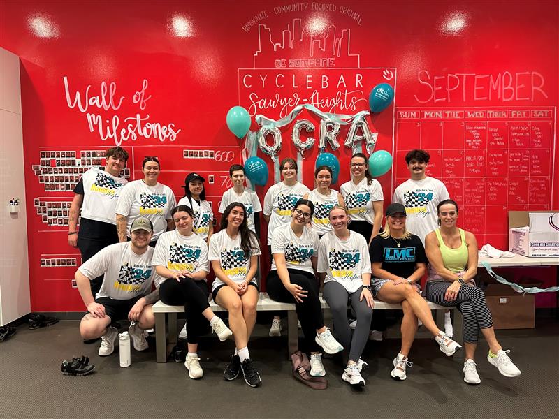 Group of OCRA fundraisers at a gym with OCRA balloons
