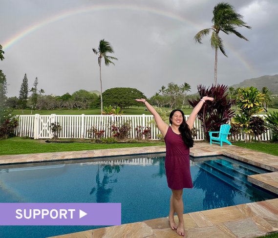 Ovarian cancer survivor standing in front of a rainbow, smiling broadly with arms raised victoriously. Text reads, Support.